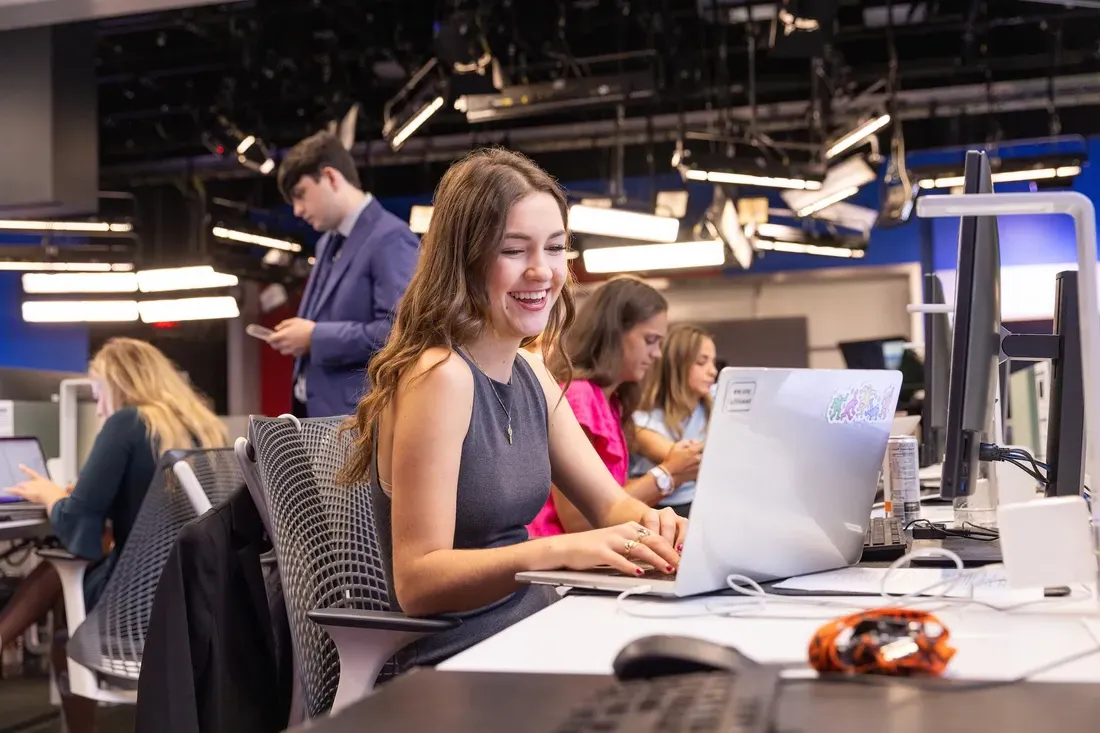 Student working on a computer during a news production class.